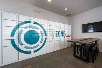 a large wall of lockers in a room with a table